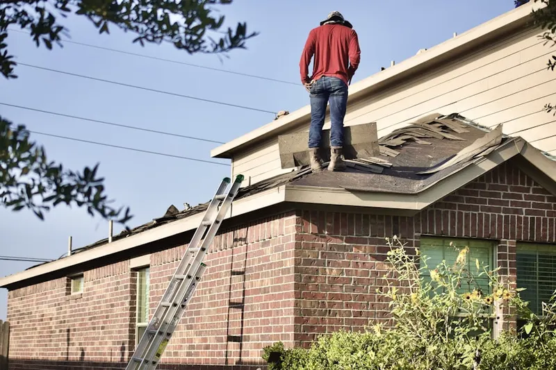 Professional roofer working on a residential roof in Youngsville